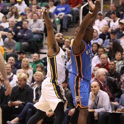 Utah Jazz point guard Mo Williams (5) gets off a shot after being fouled by Oklahoma City Thunder point guard Reggie Jackson (15) as the Utah Jazz are defeated by the Oklahoma City Thunder 90-80 as they play NBA basketball Tuesday, April 9, 2013, in Salt Lake City.