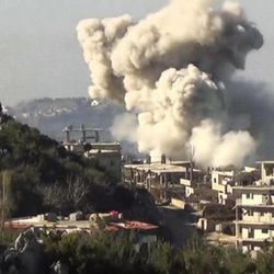 In this image taken from video obtained from the Shaam News Network, which has been authenticated based on its contents and other AP reporting, smoke rises from a building in Latakia, Syria, Wednesday, Jan. 8, 2014.
