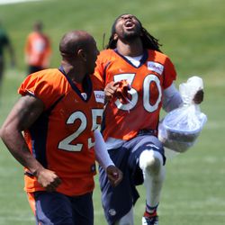 Broncos CB Chris Harris Jr. and S David Bruton Jr. share a laugh after practice at training camp