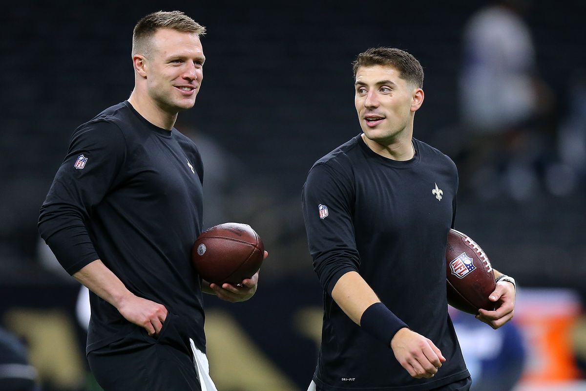 Taysom Hill #7 and Ian Book #16 of the New Orleans Saints warm up before a game against the Dallas Cowboys at the Caesars Superdome on December 02, 2021 in New Orleans, Louisiana.