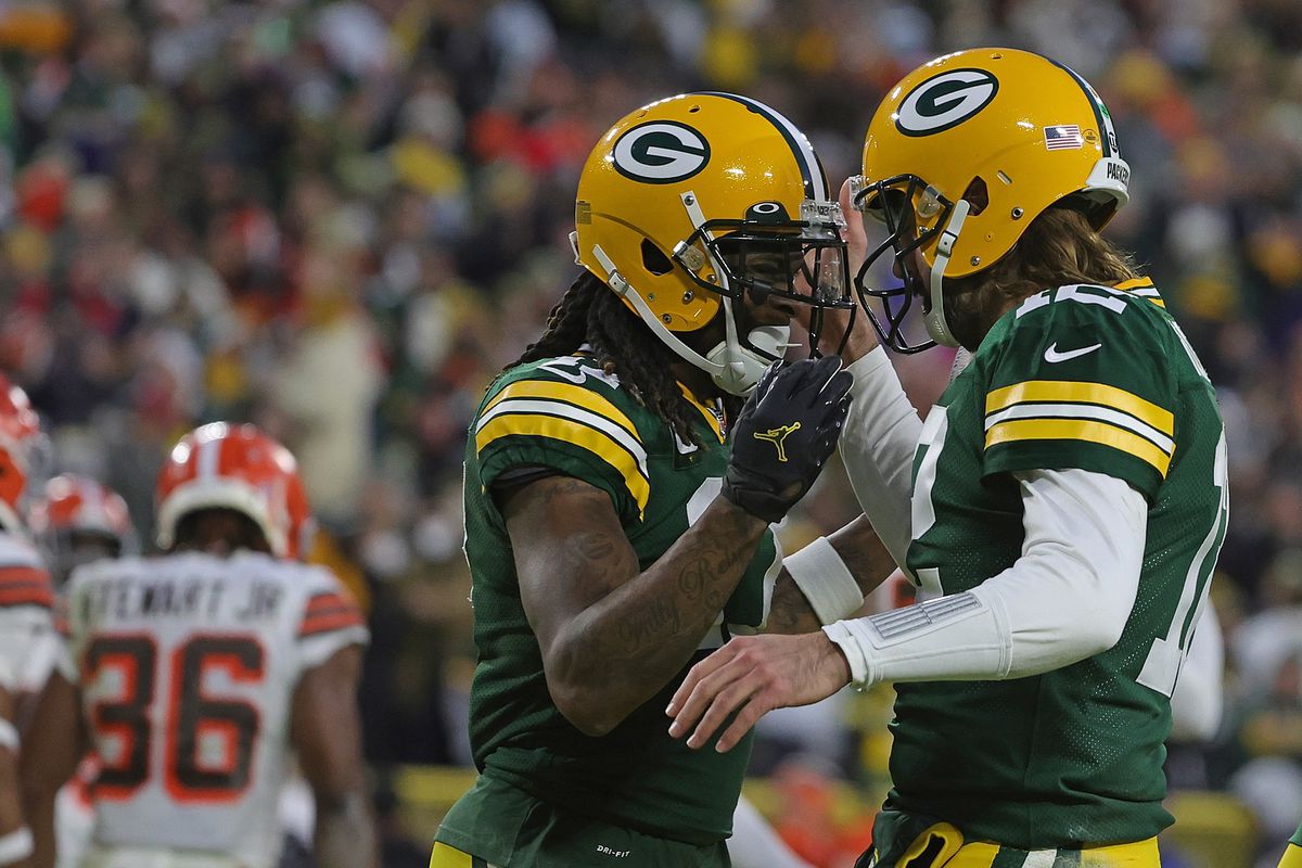 Aaron Rodgers #12 celebrates a touchdown with Davante Adams #17 of the Green Bay Packers during a game against the Cleveland Browns at Lambeau Field on December 25, 2021 in Green Bay, Wisconsin. The Packers defeated the Browns 24-22.