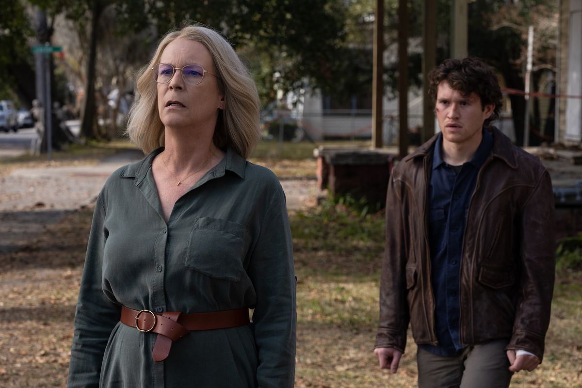 Laurie Strode (Jamie Lee Curtis) and Corey (Rohan Campbell) stand outside in daylight looking baffled in Halloween Ends