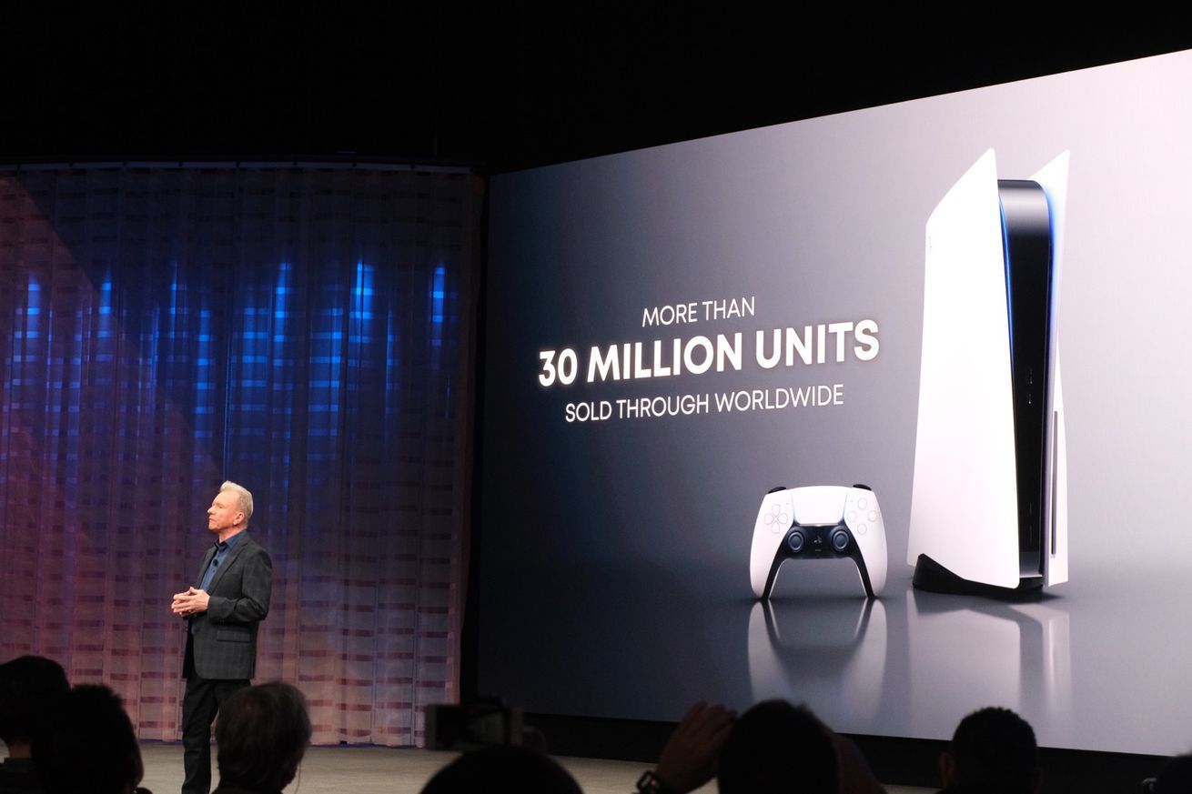 Picture of Jim Ryan standing in front of a slide that has a picture of a PlayStation 5 and the text “more than 30 million units sold through worldwide”