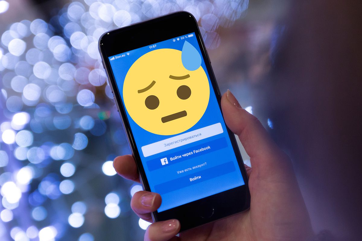 Facebook on mobile with a sad emoji.