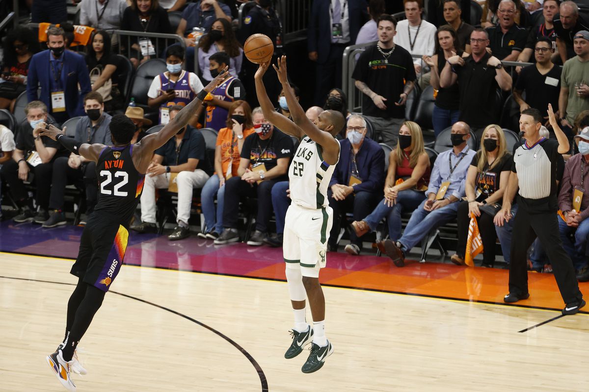Khris Middleton of the Milwaukee Bucks shoots against Deandre Ayton of the Phoenix Suns during the second half in Game One of the NBA Finals at Phoenix Suns Arena on July 06, 2021 in Phoenix, Arizona.&nbsp;
