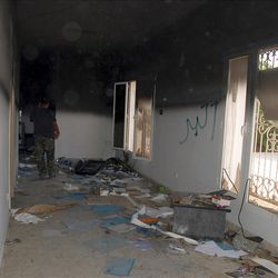 This Sept. 12, 2012 file photo shows a man walking through a room in the gutted U.S. consulate in Benghazi, Libya, after an attack that killed four Americans, including Ambassador Chris Stevens.
