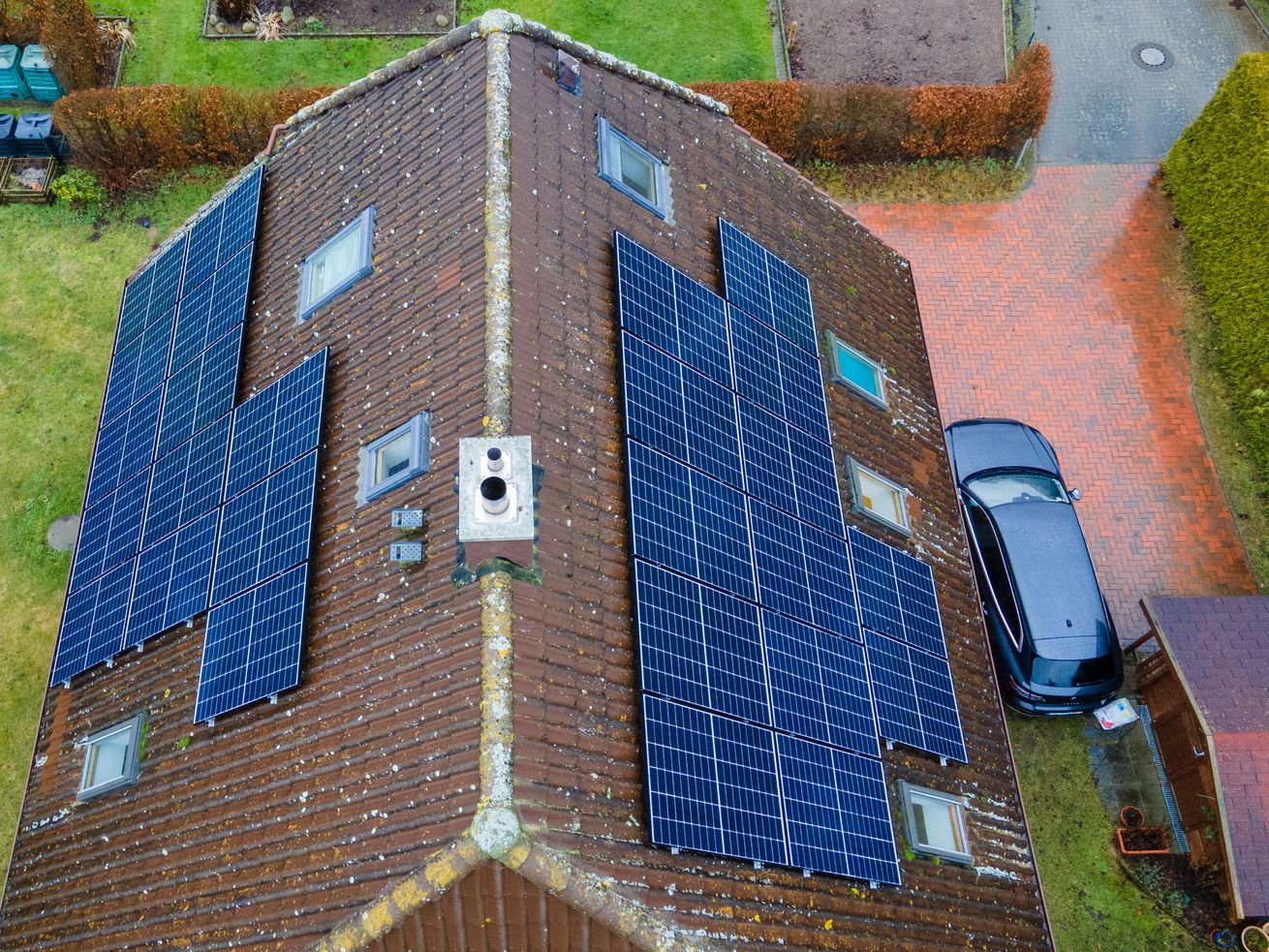 The roof of a house with solar panels, viewed from above.