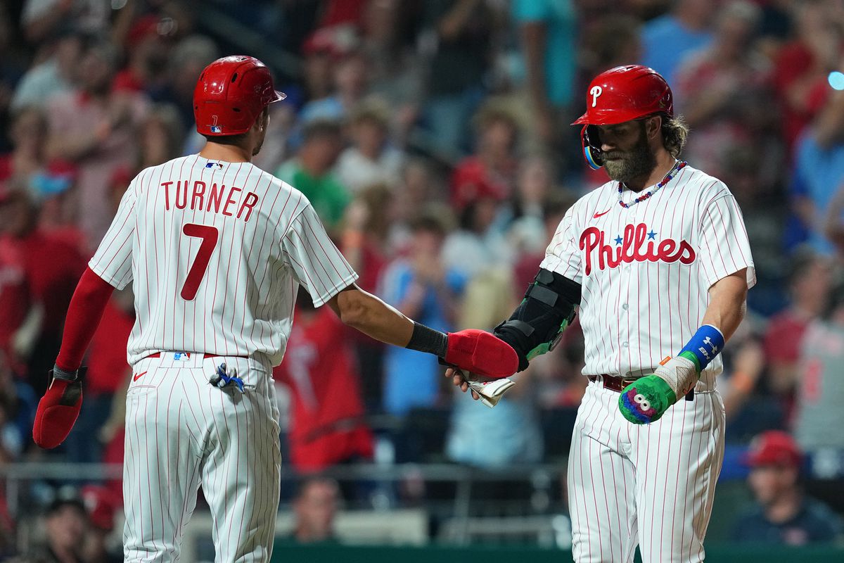 Trea Turner of the Philadelphia Phillies celebrates with Bryce Harper against the St. Louis Cardinals at Citizens Bank Park on August 26, 2023 in Philadelphia, Pennsylvania.