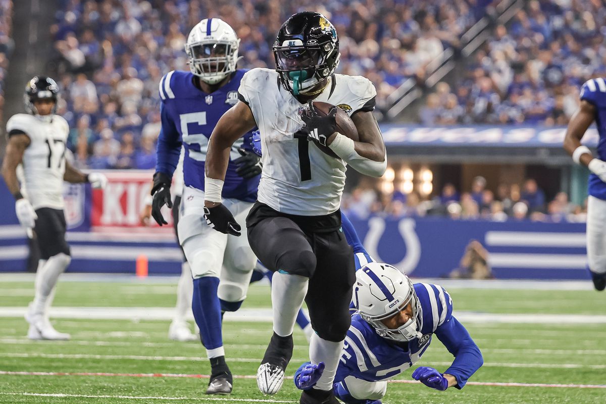 Travis Etienne Jr. #1 of the Jacksonville Jaguars runs the ball against Rodney Thomas II #25 of the Indianapolis Colts at Lucas Oil Stadium on September 10, 2023 in Indianapolis, Indiana.