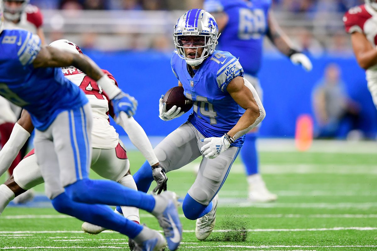 Amon-Ra St. Brown #14 of the Detroit Lions runs with the ball against the Arizona Cardinals in the fourth quarter at Ford Field on December 19, 2021 in Detroit, Michigan.