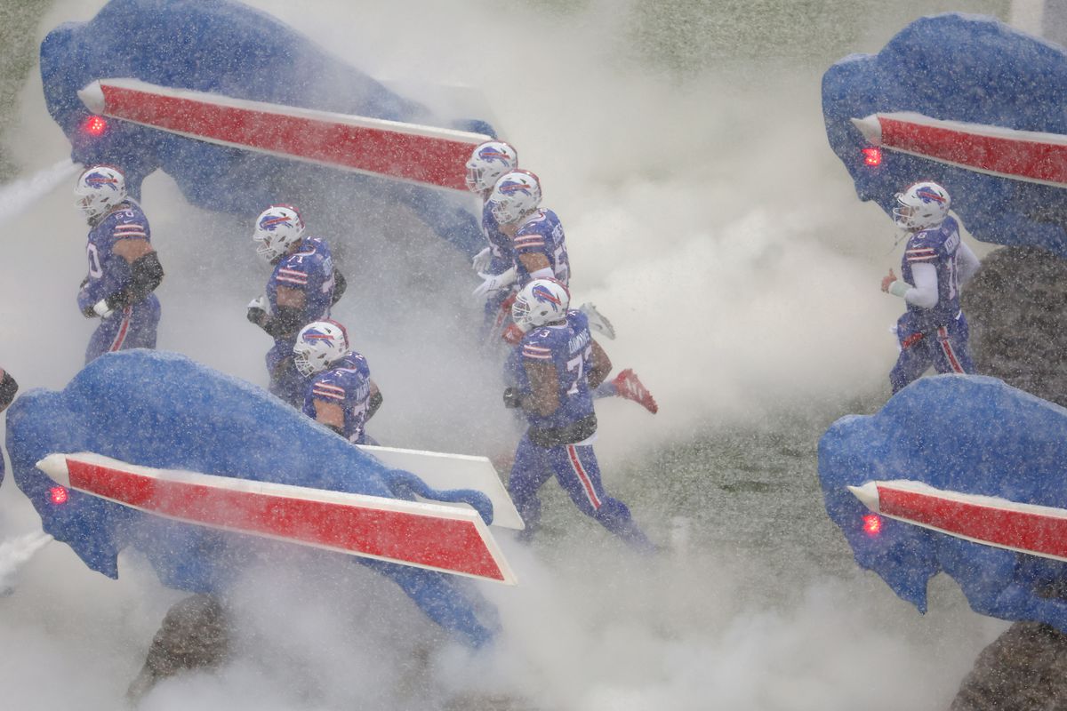 The Buffalo Bills take the field as snow falls in the AFC Divisional Playoff game against the Cincinnati Bengals at Highmark Stadium on January 22, 2023 in Orchard Park, New York.