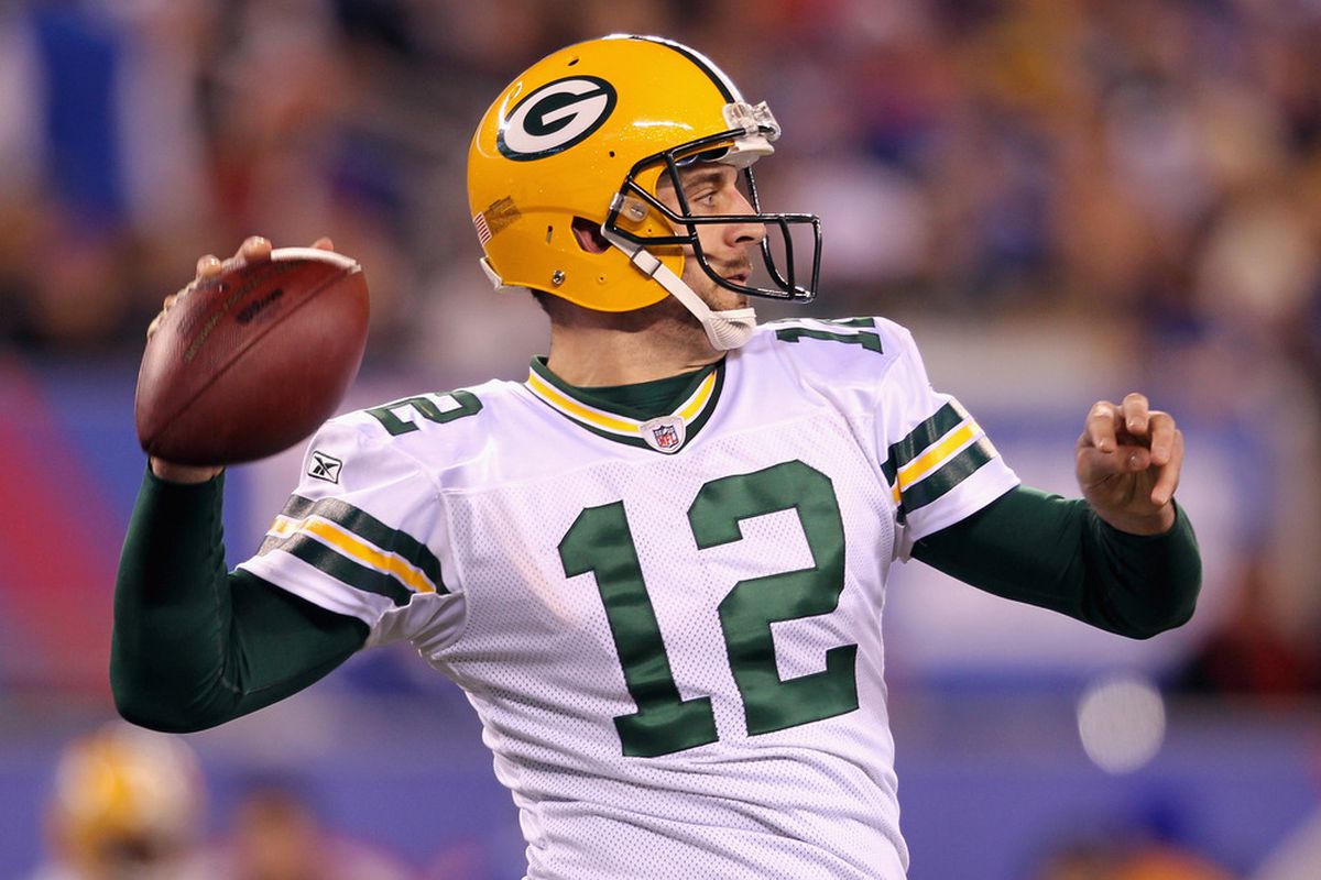 EAST RUTHERFORD, NJ - DECEMBER 04:  Aaron Rodgers #12 of the Green Bay Packers throws a pass against the New York Giants at MetLife Stadium on December 4, 2011 in East Rutherford, New Jersey.  (Photo by Nick Laham/Getty Images)