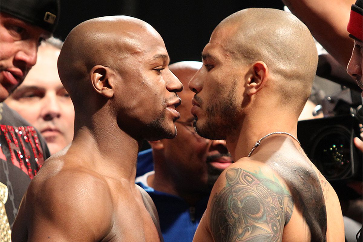 Floyd Mayweather and Miguel Cotto got the weigh-in crowed hyped up with a long, intense staredown. (Photo by Tom Hogan/Hoganphotos-Golden Boy Promotions)