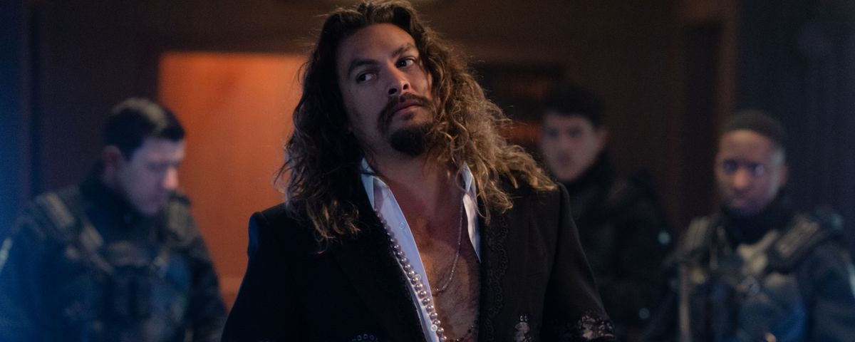 Central villain Dante (Jason Momoa) in Fast X rolls his eyes as he stands in front of some subordinates, two crossed knives in his hands