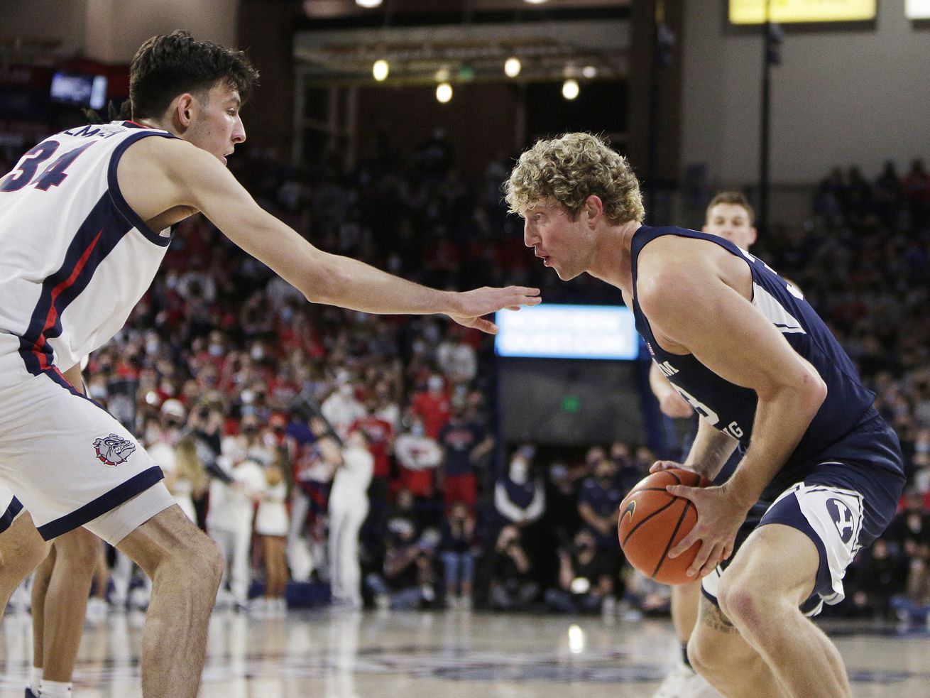 BYU forward Caleb Lohner, right, controls the ball while defended by Gonzaga center Chet Holmgren in Spokane, Wash.