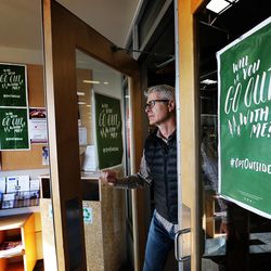 Ron Kramer walks by #OptOutside signs as leaves REI in Sandy on Thursday, Nov. 17, 2016. REI will be closed on Black Friday so employees can spend time with friends and family.