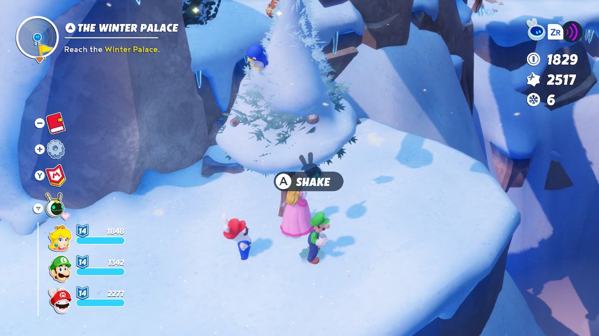 Peach, Rabbid Mario, and Luigi prepare to shake a baby blue penguin out of a pine tree in Mario + Rabbids Sparks of Hope