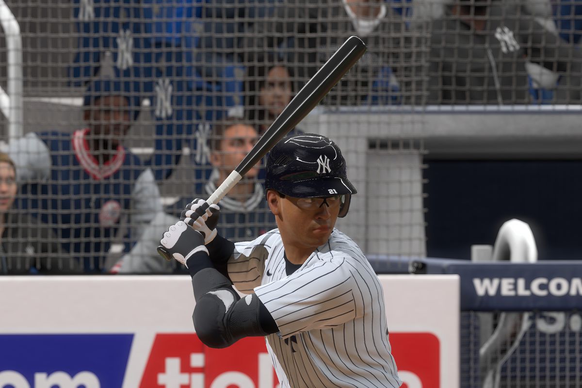 a close-up of a brown-skinned man wearing a New York Yankees jersey awaiting a pitch at Yankee Stadium in a night game in MLB The Show 20