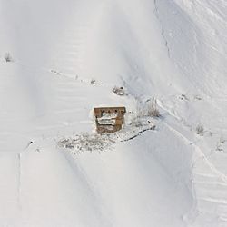 A house is cover with snow from an avalanche in the Paryan district of Panjshir province, north of Kabul, Afghanistan, Friday, Feb. 27, 2015. The death toll from severe weather that caused avalanches and flooding across much of Afghanistan has jumped to more than 200 people, and the number is expected to climb with cold weather and difficult conditions hampering rescue efforts, relief workers and U.N. officials said Friday. 