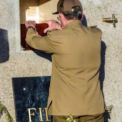 Cuba's President Raul Castro places the ashes of his older brother Fidel Castro into a niche in his tomb, a simple, grey, round stone about 15 feet high at the Santa Ifigenia cemetery in Santiago, Cuba, Sunday Dec.4, 2016. The niche was then covered by a plaque bearing the single name,"Fidel."