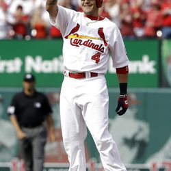 St. Louis Cardinals' Yadier Molina celebrates after reaching base on a fielding error by Cincinnati Reds center fielder Shin-Soo Choo during the first inning of a baseball game Monday, April 8, 2013, in St. Louis. Two runs scored on the play. (AP Photo/Jeff Roberson)