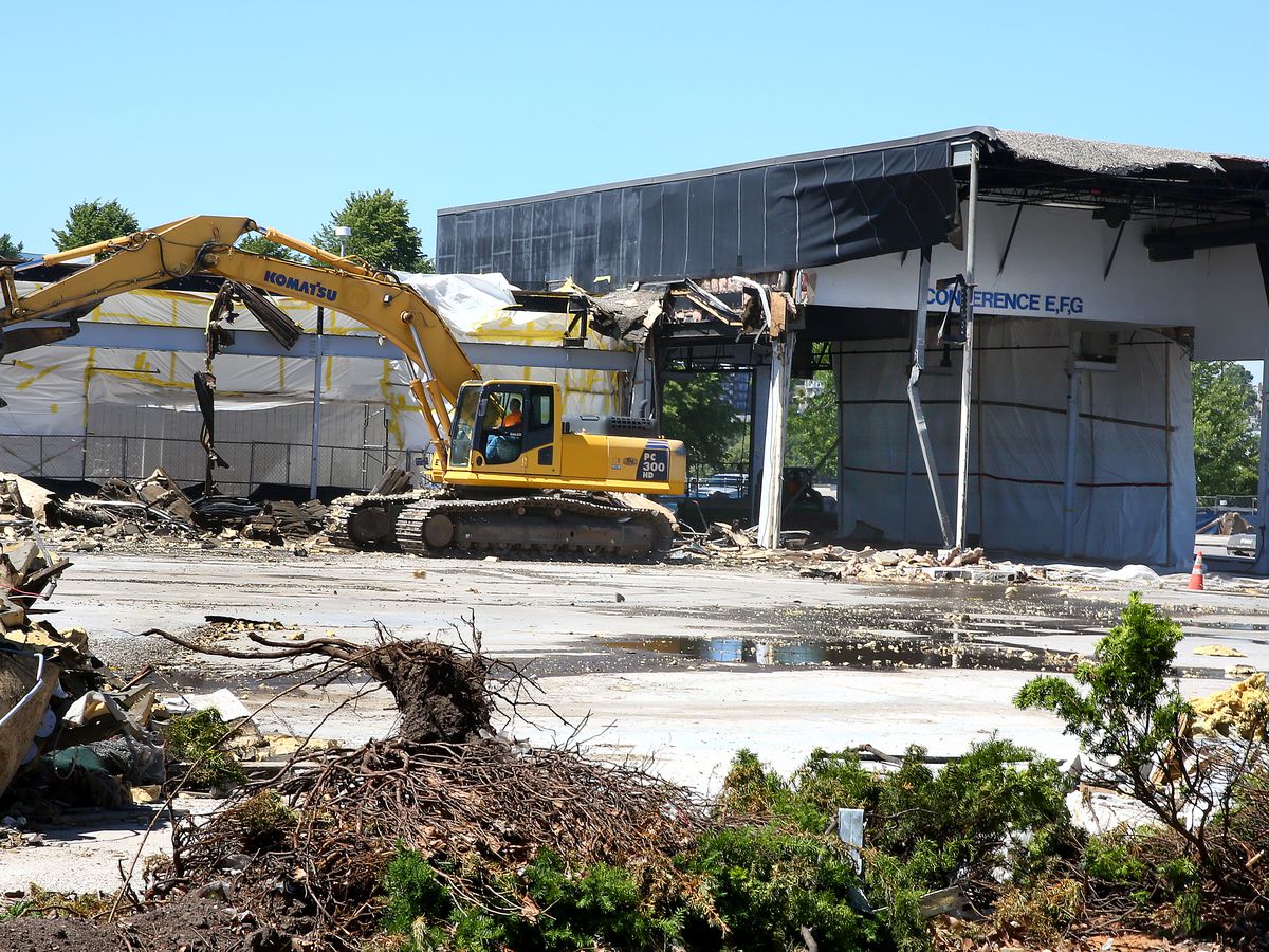 Construction equipment demolishing an old mall site.