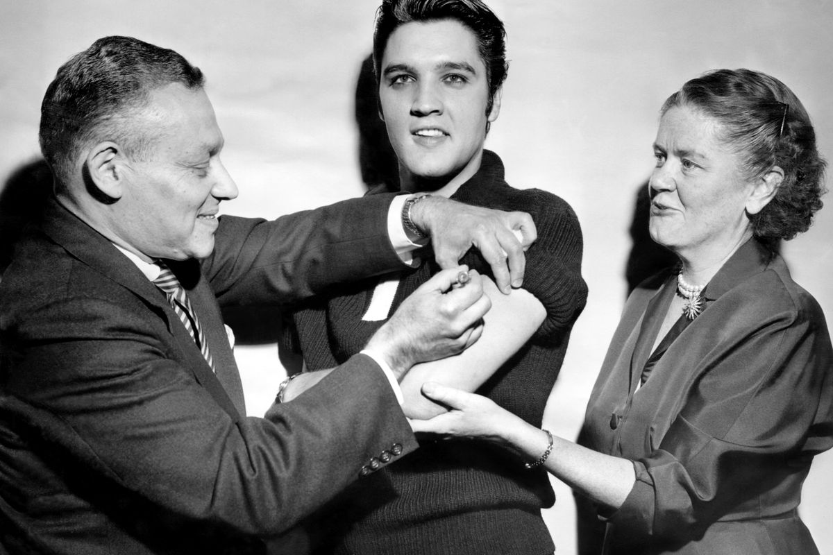Elvis Presley receiving a polio vaccination from Dr. Leona B