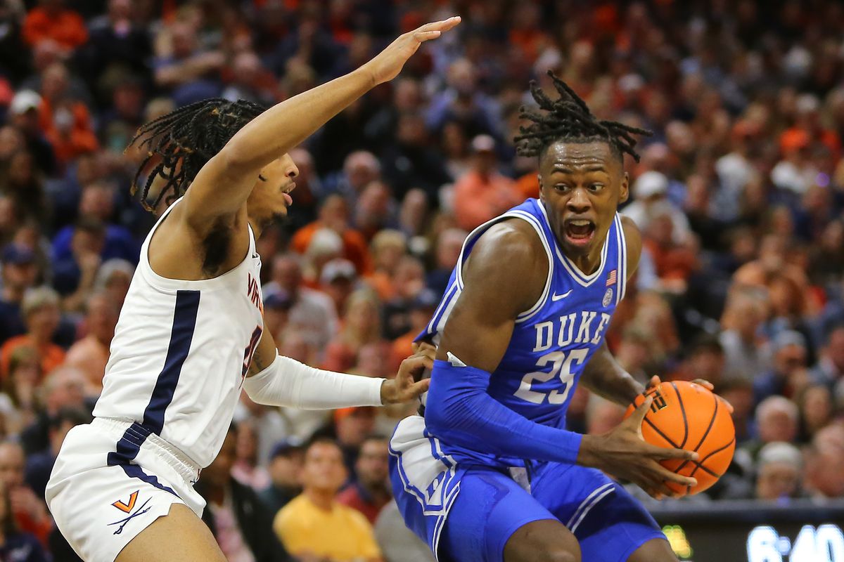 Virginia Cavaliers guard Armaan Franklin (4) attempts to defend Duke Blue Devils forward Mark Mitchell (25) during a men’s college basketball game between the Duke Blue Devils and the Virginia Cavaliers on February 11, 2023, at John Paul Jones Arena in Charlottesville, VA.