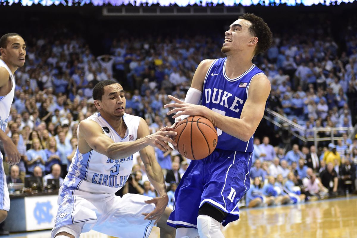 Mar 7, 2015; Chapel Hill, NC, USA; North Carolina Tar Heels guard Marcus Paige (5) and Duke Blue Devils guard Tyus Jones (5) fight for the ball in the second half. The Blue Devils defeated the Tar Heels 84-77 at Dean E. Smith Center. 