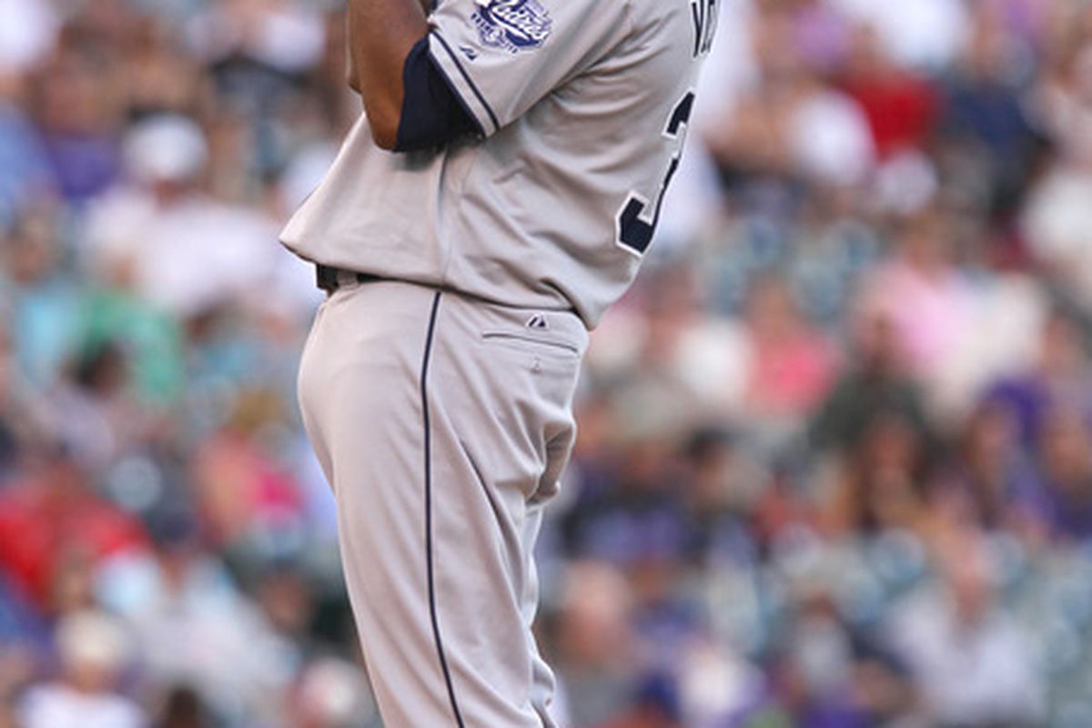 June 30, 2012; Denver, CO USA; San Diego Padres starting pitcher Edinson Volquez stretches while preparing to face a Colorado Rockies batter at Coors Field. Mandatory Credit: Andrew Carpenean-US PRESSWIRE