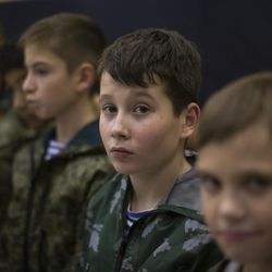 In this photo taken on Friday, Oct. 28, 2016, Russian children listen to a trainer in parachute techniques in Verkhnyaya Pyshma, just outside Yekaterinburg, Russia. The training has been run by Yunarmia (Young Army), an organization sponsored by the Russian military that aims to encourage patriotism among the Russian youth. 