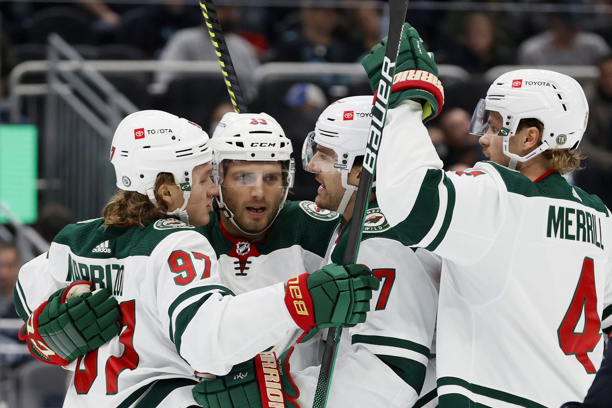 Ryan Hartman #38 of the Minnesota Wild celebrates his goal with Kirill Kaprizov #97, Marcus Foligno #17 and Jon Merrill #4 against the Seattle Kraken during the first period on October 28, 2021 at Climate Pledge Arena in Seattle, Washington.