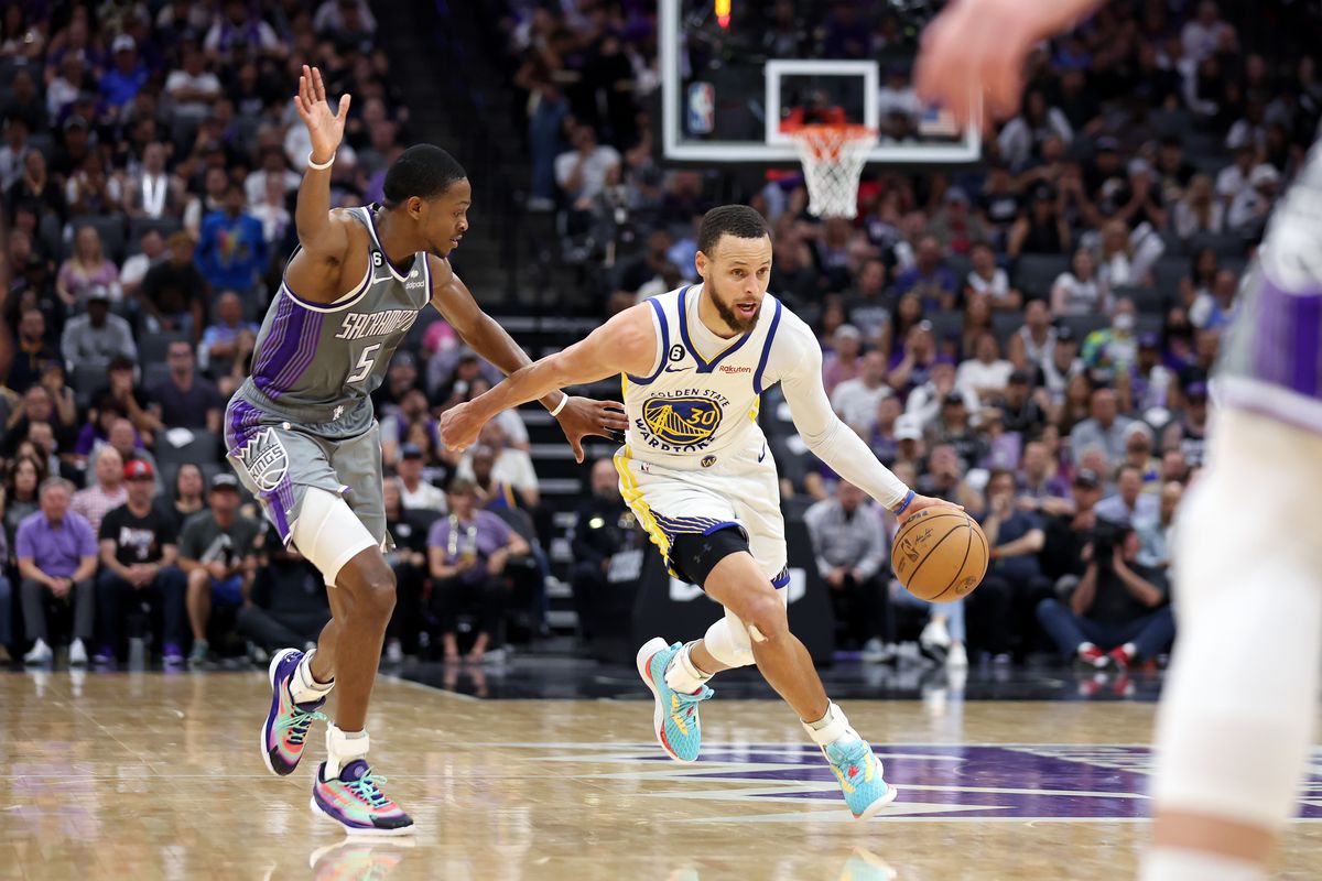 SACRAMENTO, CALIFORNIA - APRIL 26: Stephen Curry #30 of the Golden State Warriors is guarded by De’Aaron Fox #5 of the Sacramento Kings during the second half of Game Five of the Western Conference First Round Playoffs at Golden 1 Center on April 26, 2023 in Sacramento, California.