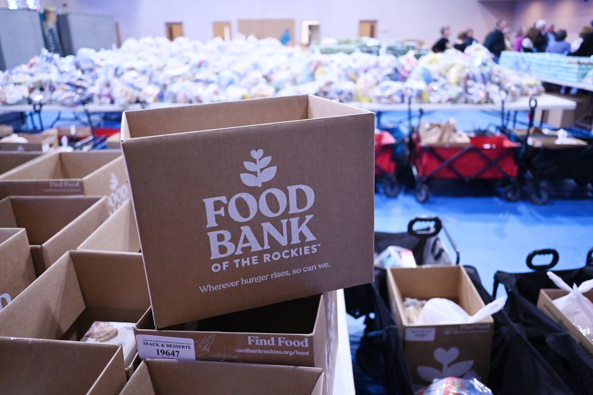 Stacked cardboard boxes labeled “Food Bank of the Rockies.”