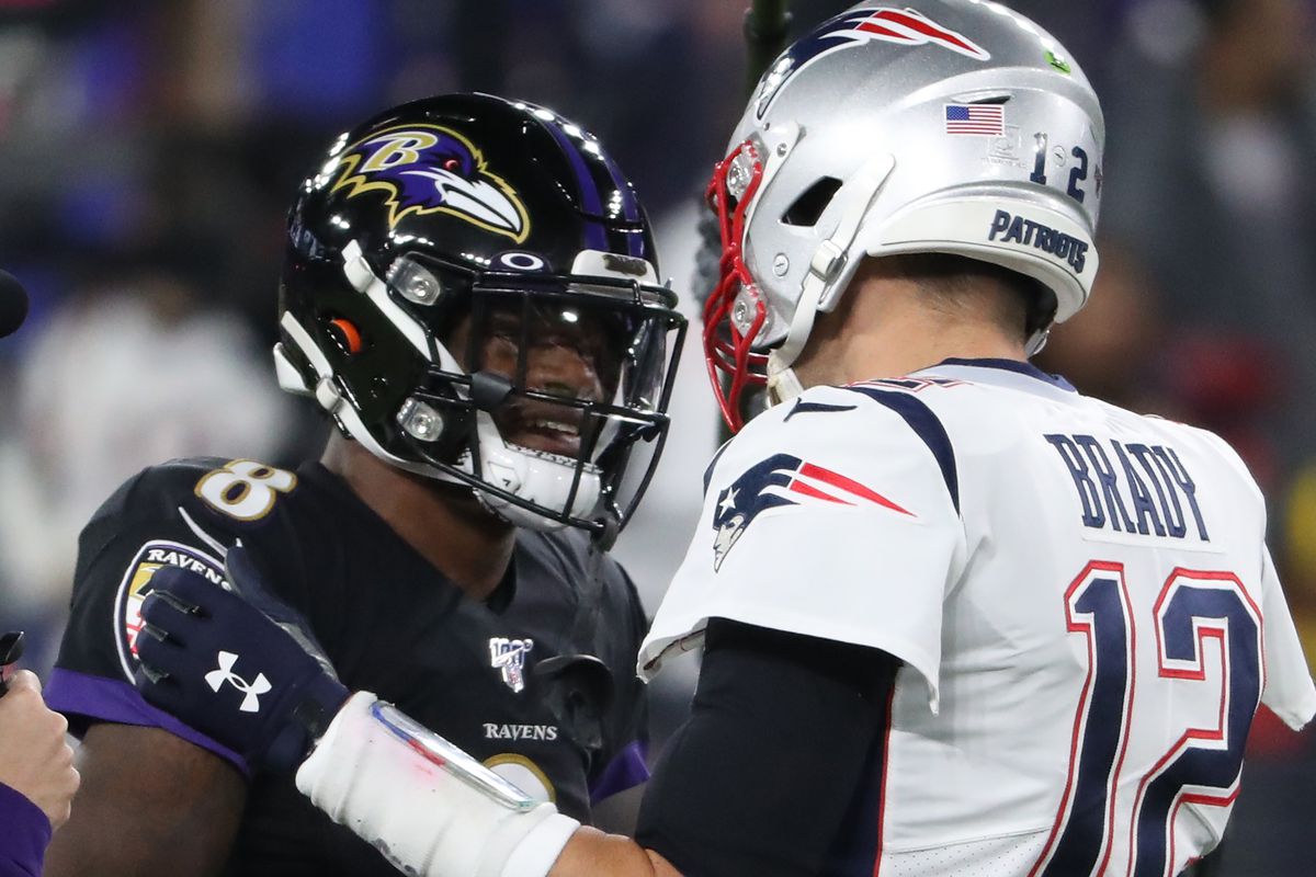 Quarterback Tom Brady of the New England Patriots and quarterback Lamar Jackson of the Baltimore Ravens talk before playing in an NFL game at M&amp;T Bank Stadium on November 3, 2019 in Baltimore, Maryland.