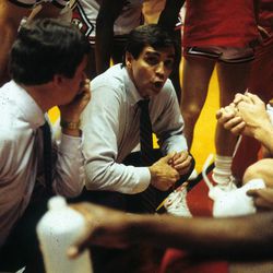 Lynn Archibald, center, talks with the Utes during a timeout. Archibald recruited Mitch Smith to Utah and became a close friend and mentor.