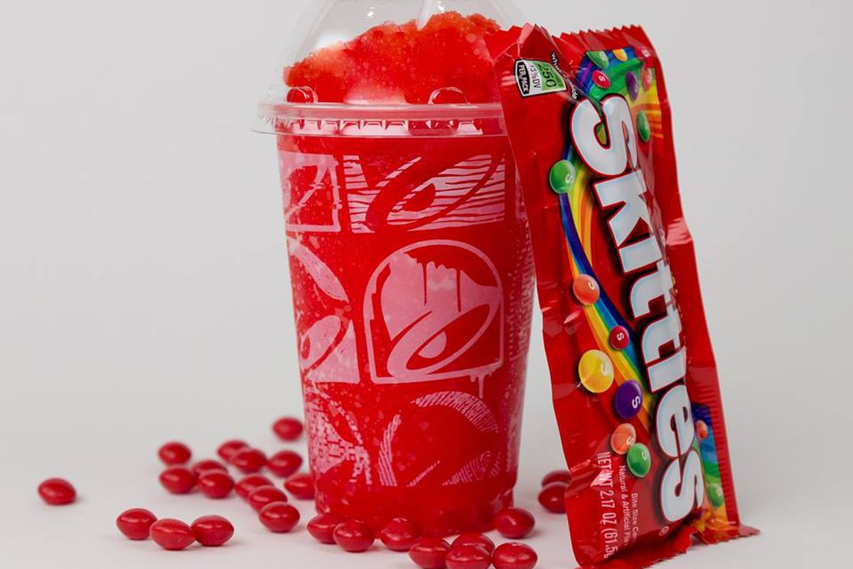 A Taco Bell skittles slushie and a bag of skittles