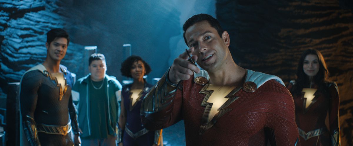 Zachary Levi as Shazam, with the other Shazams, in a still from the movie.