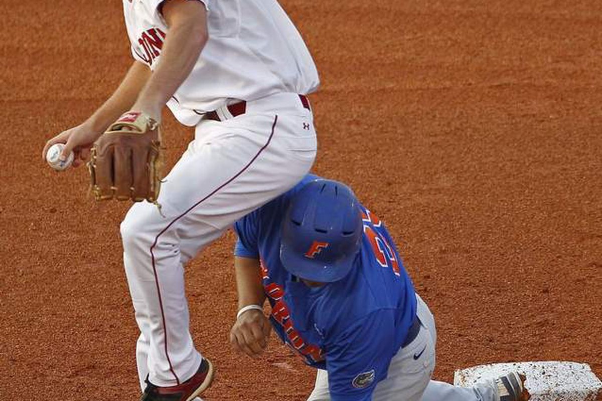 <em>See you in Omaha, hopefully:  UF's Preston Tucker breaks up a DP attempt by USC's Joey Pankake in yesterday's elimination game in the SEC Tournament.  The Gators won 7-2.</em>