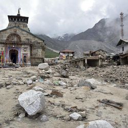 In this Thursday June 20, 2013 photo, the Kedarnath shrine, one of the holiest of Hindu temples dedicated to Lord Shiva, and other buildings around it are seen damaged following monsoon rains in at Kedarnath  in the northern Indian state of Uttrakhand. A joint army and air force operation are trying to evacuate thousands of people stranded in the upper reaches of the state of Uttrakhand where days of rain had earlier washed out houses, temples, hotels and vehicles leading to deaths of over a hundred people amid fears that the death toll may rise much higher. (AP Photo)