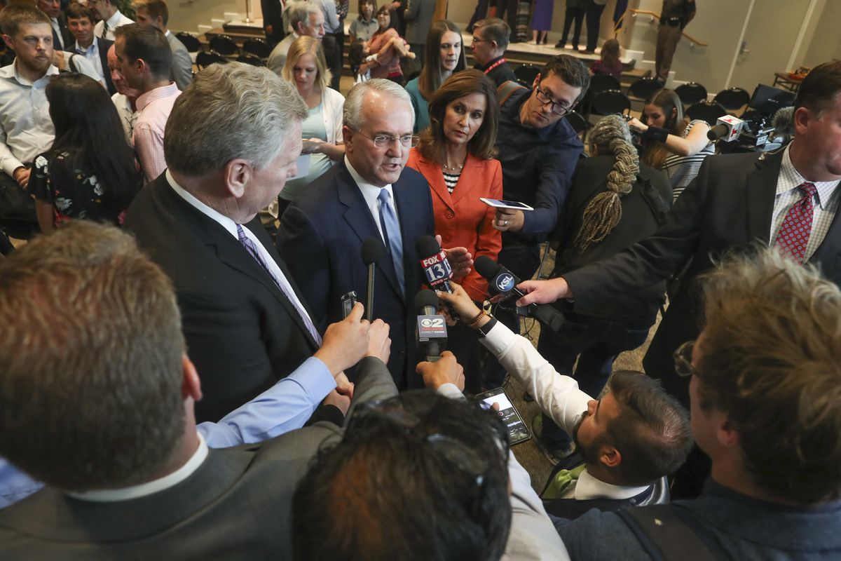 FILE - Elder Jack Gerard, a General Authority Seventy of The Church of Jesus Christ of Latter-day Saints, center, talks with members of the media after a broad coalition of Utah community leaders announced its opposition to Utah's medical marijuana ballot