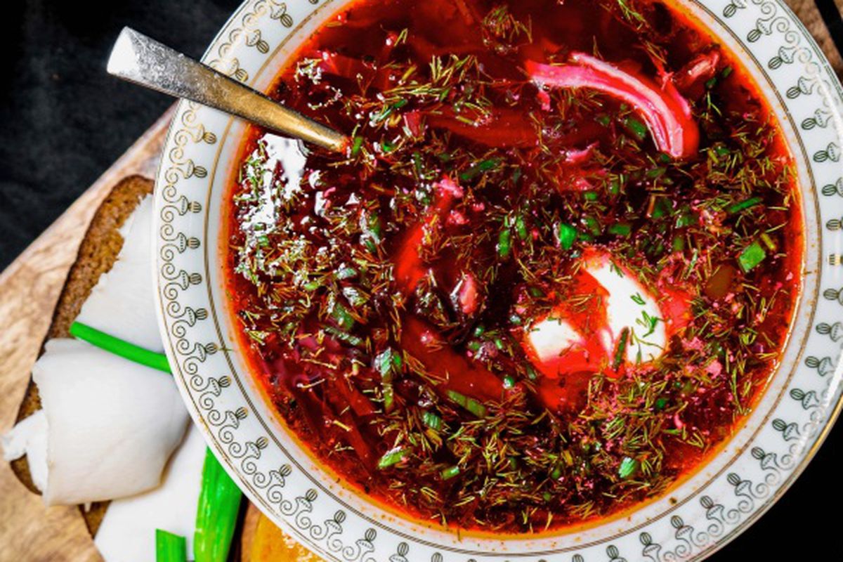 A bowl of red borscht soup.