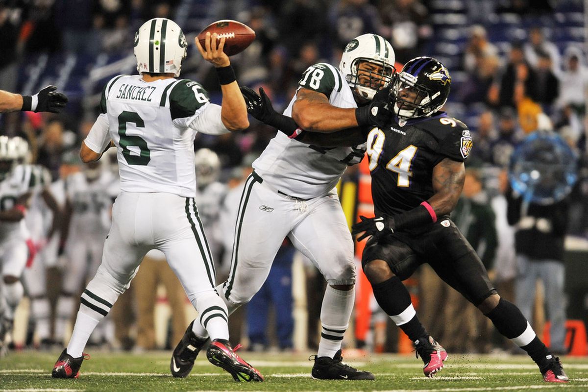 BALTIMORE - OCTOBER 2:  Sergio Kindle #94 of the Baltimore Ravens rushes Mark Sanchez #6 of the New York Jets at M&T Bank Stadium on October 2. 2011 in Baltimore, Maryland. The Ravens defeated the Jets 34-17. (Photo by Larry French/Getty Images)