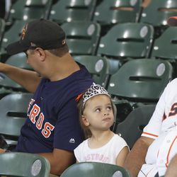 Jul 31, 2022; Houston, Texas, USA; Harper McGee, age 3, from Texas looks at her grandpa after she was refused candy before the Houston Astros play against the Seattle Mariners at Minute Maid Park. Today was Princess Day at the park. Mandatory Credit: Thomas Shea