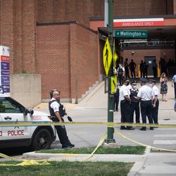 Police officers gather outside Advocate Illinois Masonic Medical Center after an officer was shot at the 25th District police station on the Northwest Side, Thursday, July 30, 2020.