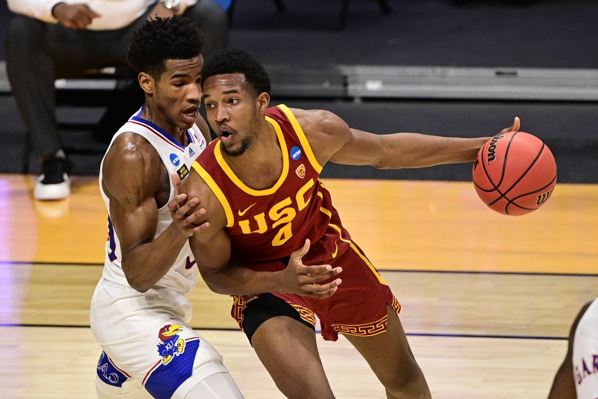 Southern California Trojans forward Evan Mobley handles the ball while Kansas Jayhawks guard Ochai Agbaji defends during the first half in the second round of the 2021 NCAA Tournament at Hinkle Fieldhouse.