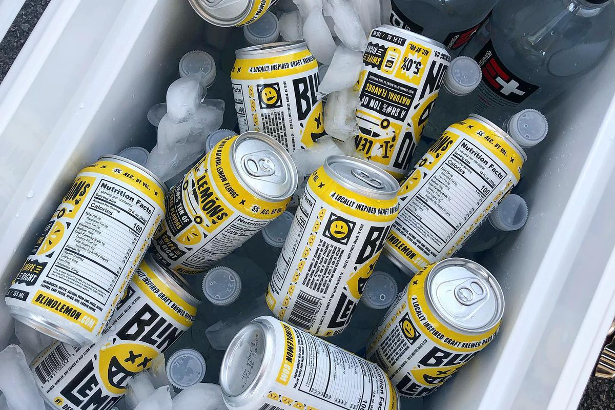 Cans of Blind Lemon spiked seltzer in a white cooler with ice