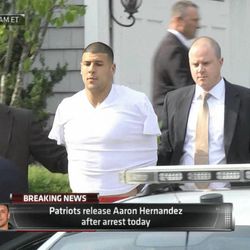 In this image taken from video, police escort Aaron Hernandez from his home in handcuffs in Attleboro, Mass., Wednesday, June 26, 2013. Hernandez was taken from his home more than a week after a Boston semi-pro football player was found dead in an industrial park a mile from Hernandez's house. (AP Photo/ESPN) 