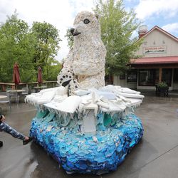 Visitors look at Daisy the Polar Bear, a sculpture made entirely of plastic garbage found in the oceans, at Utah Hogle Zoo's Rocky Shores exhibit in Salt Lake City on Friday, May 24, 2019.