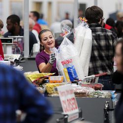 Betty Fletes helps customers through the checkout area of the world's largest Costco, 1818 S. 300 West, in Salt Lake City on Friday, Oct. 30, 2015.